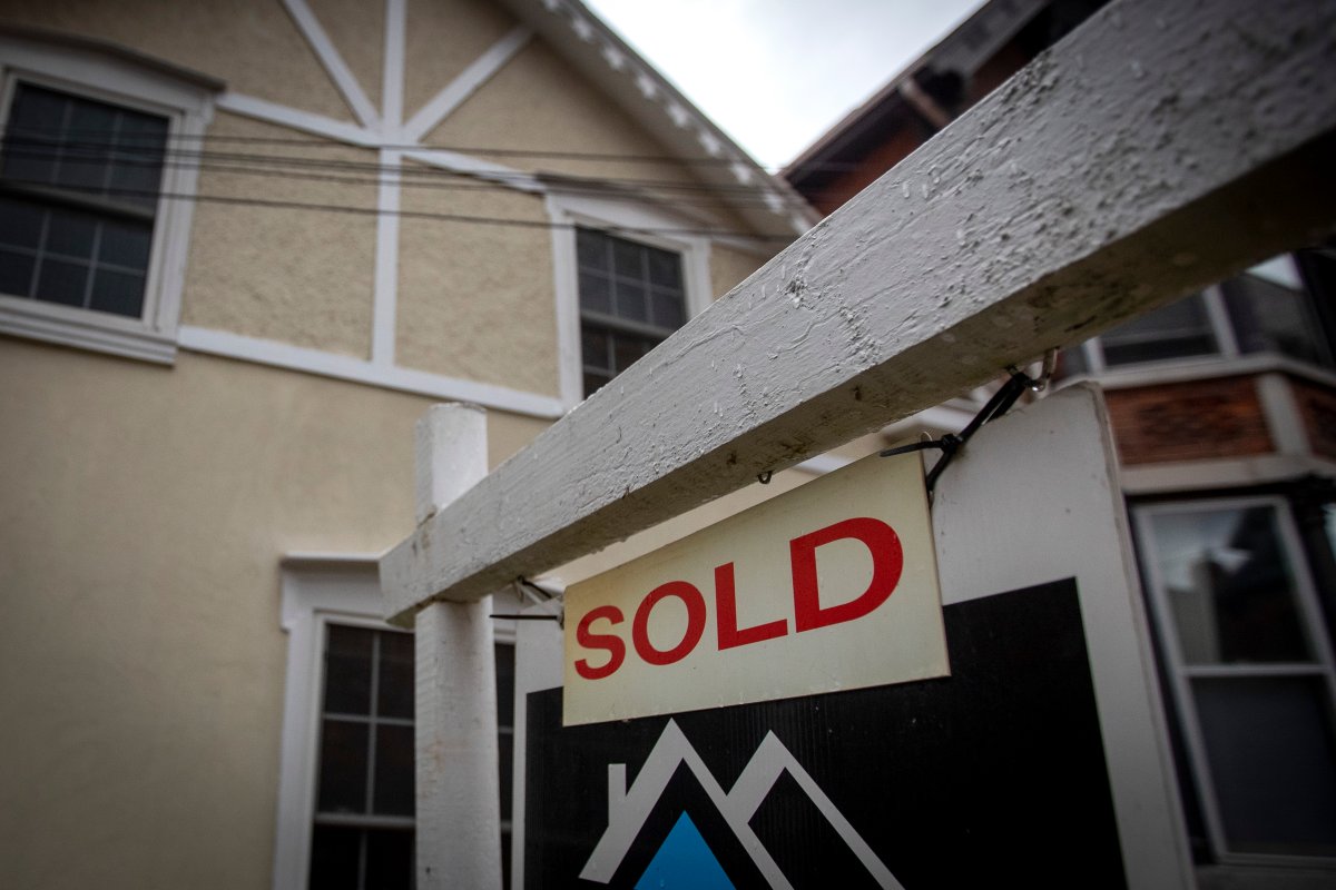 A realtor's sign is pictured in front of a house in Kingston, Ont., on Tuesday, Oct. 18, 2022.
