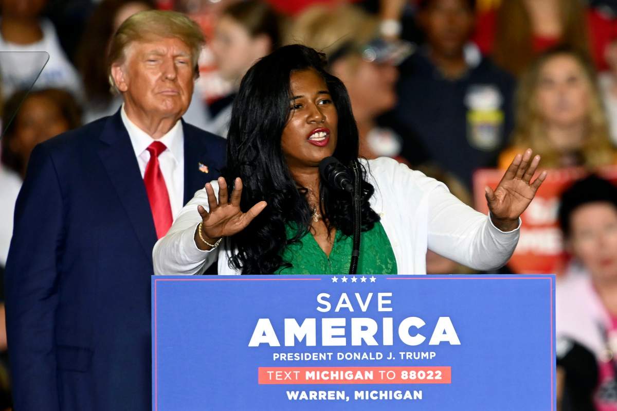 Former President Donald Trump, left, listens as Michigan Republican secretary of state candidate Kristina Karamo speaks during a rally in Warren, Mich., Oct. 1, 2022. (Todd McInturf/Detroit News via AP, File)