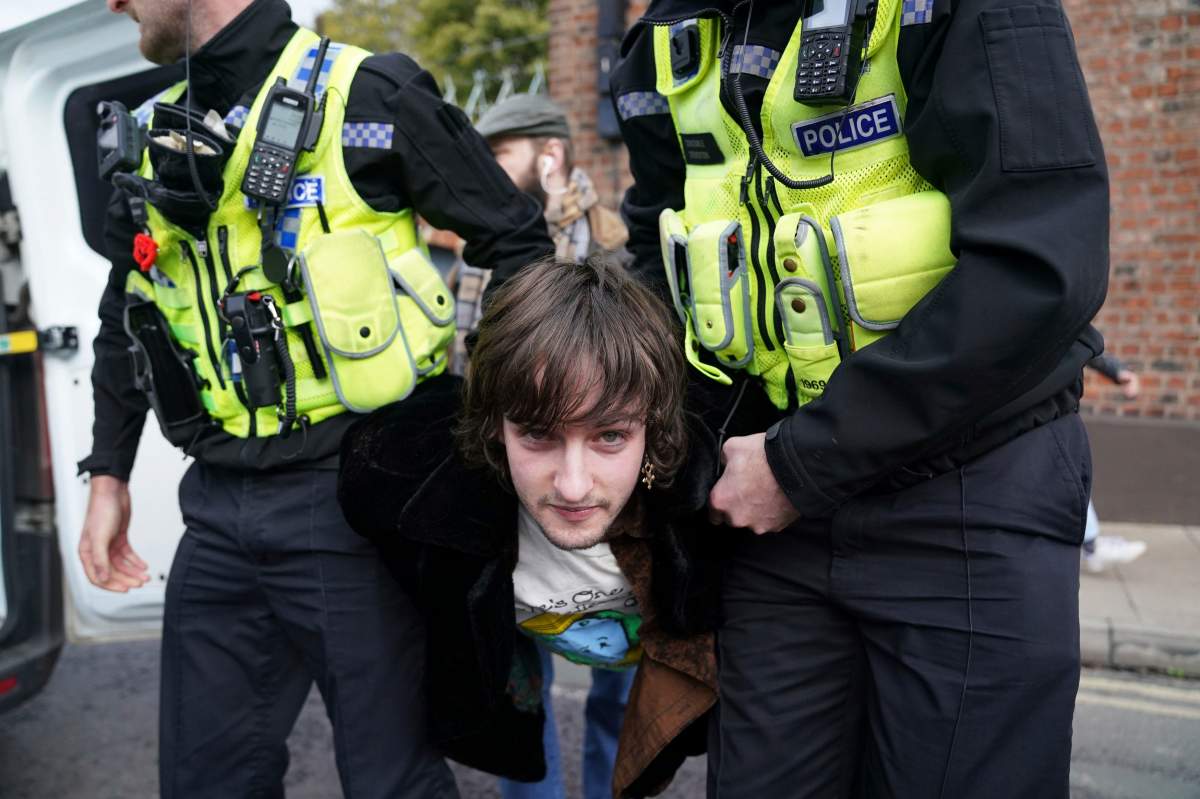 Police detain a protester after he appeared to throw eggs at Britain's King Charles III and the Queen Consort as they arrived for a ceremony at Micklegate Bar, where the Sovereign is traditionally welcomed to the city, in York, England, Wednesday Nov. 9, 2022.