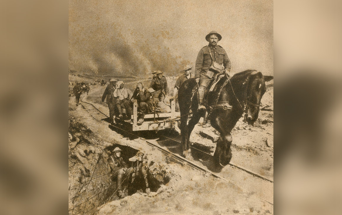 Wounded Canadian soldiers during the First World War en route to a rear dressing station in 1917. The horse-drawn, narrow rails were useful along the water-logged battlefields of Flanders.