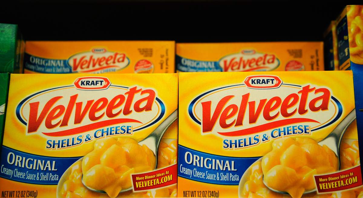 Boxes Velveeta Shells and Cheese sit on a store shelf.