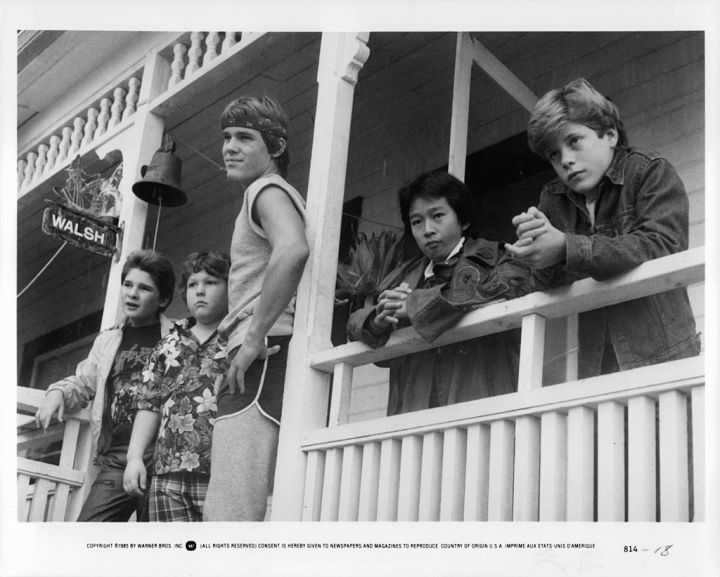 From left to right, Corey Feldman, Jeff Cohen, Josh Brolin, Ke Huy Quand and Sean Astin standing on porch in a scene from the film 'The Goonies', 1985.