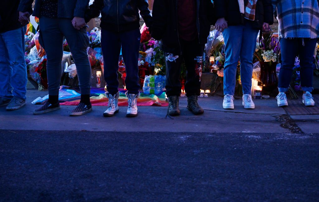 People link together in a chain at a memorial near Club Q where a 22-year-old gunman entered an LGBTQ nightclub killing at least five people and injuring 25 others on November 20, 2022 in Colorado Springs, Colorado.