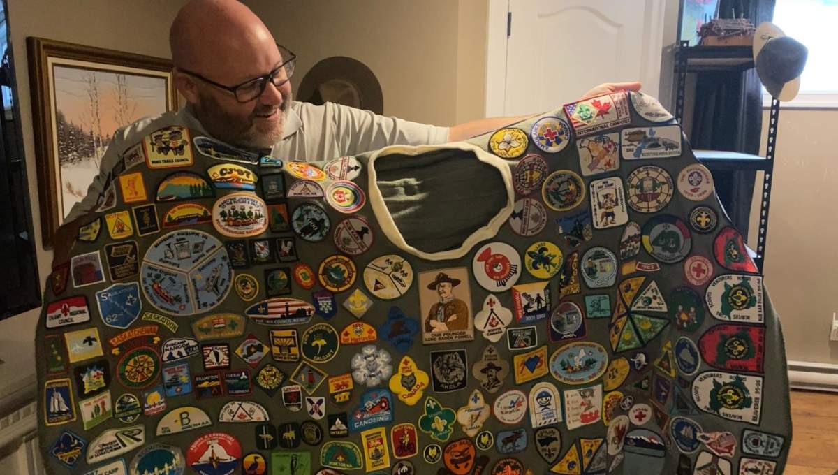 Jeff Melvin, Scoutmaster for the the Moncton 1st BPSA holds a blanket covered in Scouts badges.