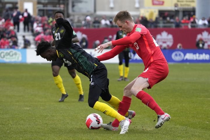 Canada’s Scott Kennedy pushes Jamaica’s Daniel Green during first half CONCACAF World Cup soccer qualifying action in Toronto on March 27, 2022.