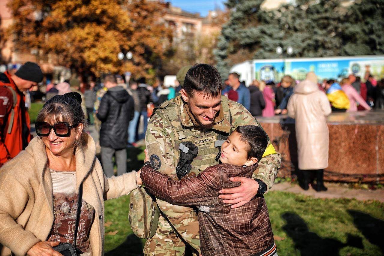 Boy hugs Ukrainian soldier