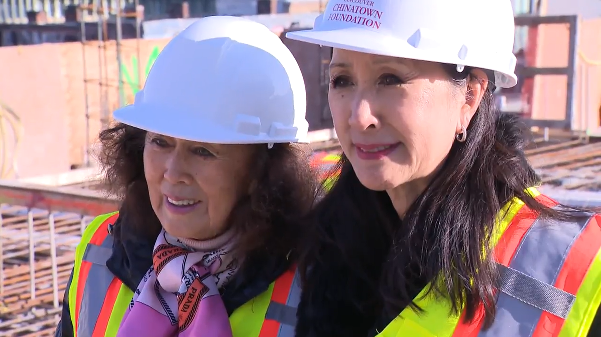 Former public health nurse Lily Lee stands with daughter Carol Lee, chair of the Vancouver Chinatown Foundation, atop an upcoming community health centre named in Lily's honour at 58 West Hastings Street, on Tues. Nov. 15, 2022.