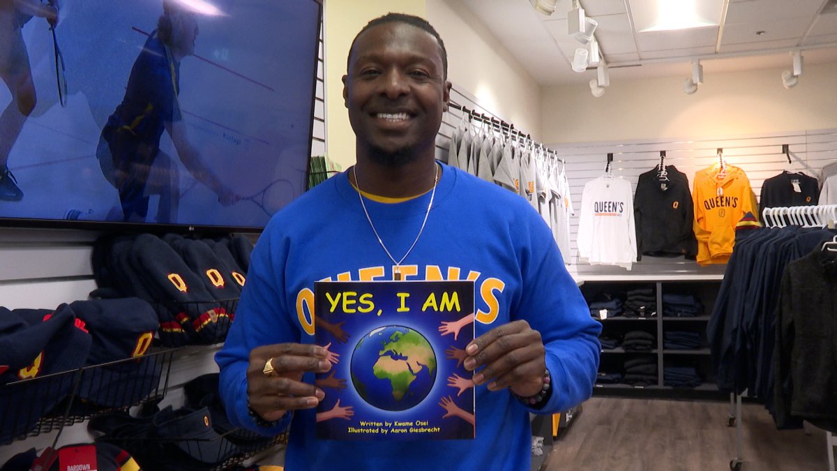 Kwame Osei poses with a copy of his book 'Yes, I am.'.