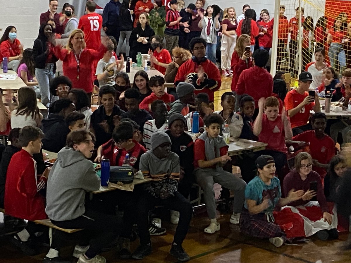 At St. Nicholas Catholic Junior High in Edmonton, where Davies attended the school's football academy and played, students filled a gym where the Canadian star used to play to cheer on their favorite student.