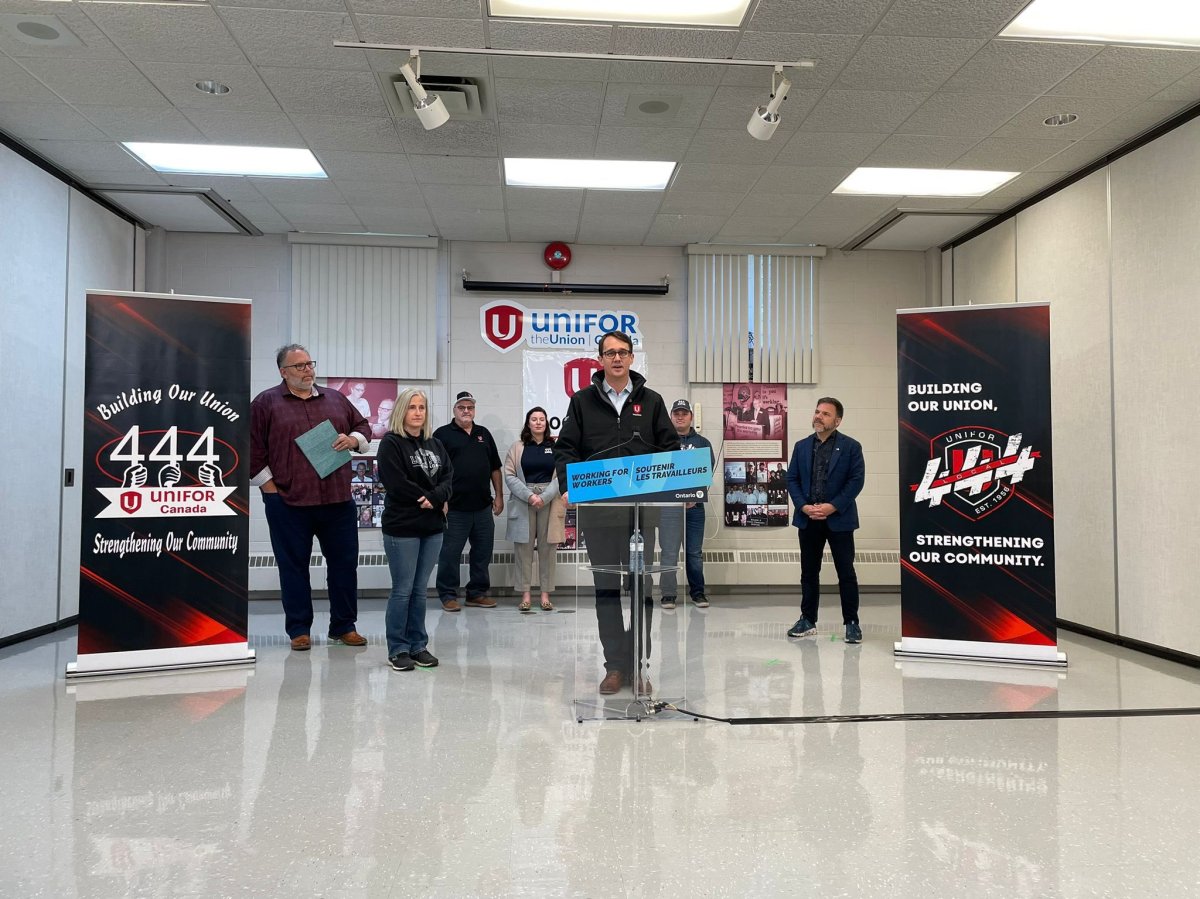 Labour Minister Monte McNaughton speaks from a podium during Friday's media conference about new support for recently laid off workers in Windsor.