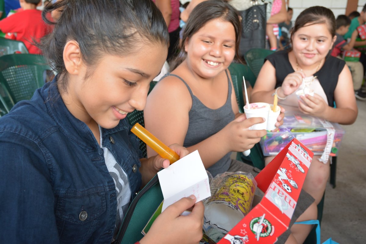 Kids opening shoeboxes in El Salvador during an Operation Christmas Child shoebox distribution trip.