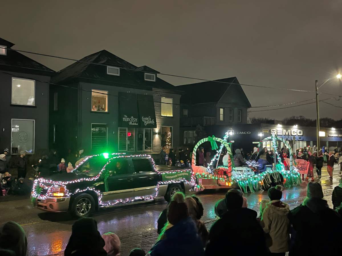 A parade float all lit up in the night.