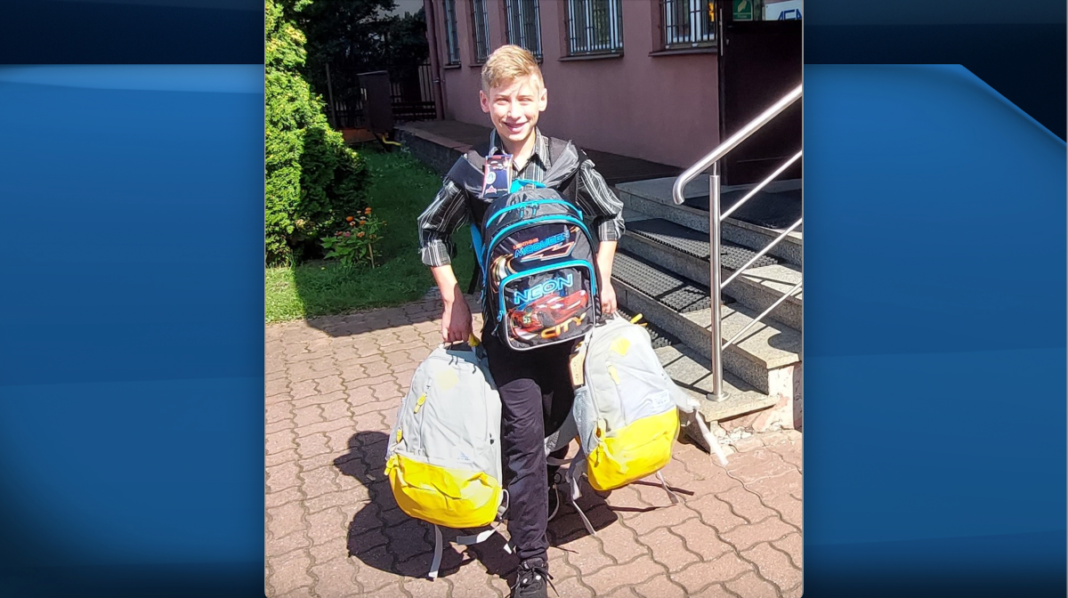 Oscar Oliver holding backpacks to donate to children fleeing the war in Ukraine. 