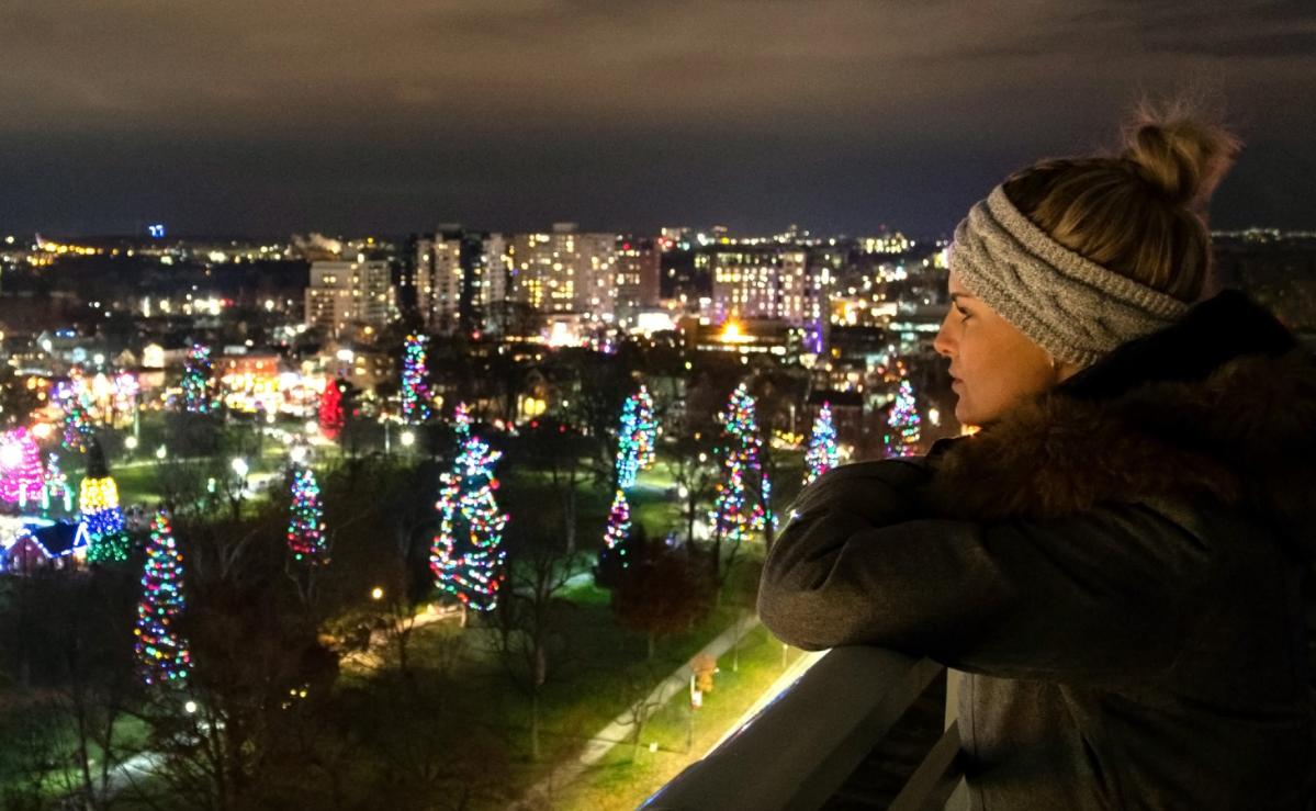 A Londoner views festive lights in Victoria Park from the observation deck on top of city hall.