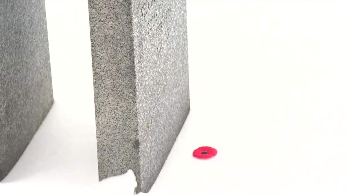 A poppy placed at the headstone of a soldier buried at Beechmount Cemetery during the No Stone Left Alone remembrance ceremony in Edmonton, Alta. on Monday, Nov. 7, 2022.