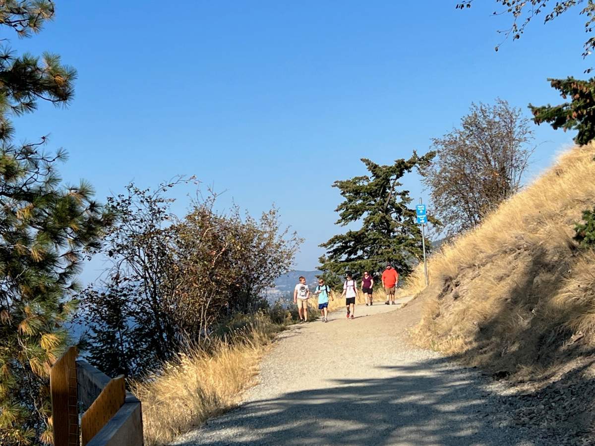 Children sported shorts and tshirts as they walked along the trails at Knox Mountain in October. 