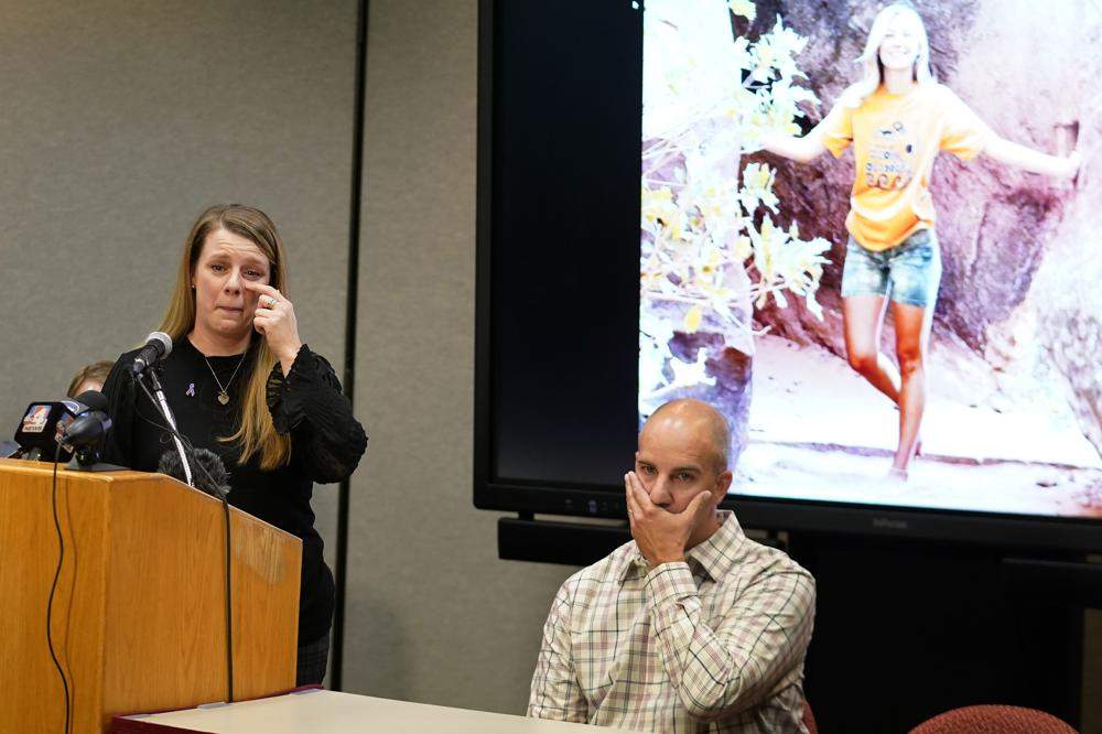 Nichole Schmidt and Joseph Petito in front of an image of Gabby Petito.