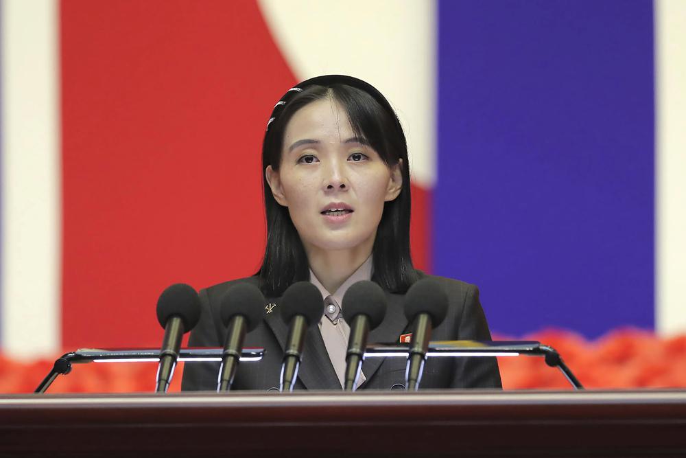 Kim Yo Jong standing at a podium.