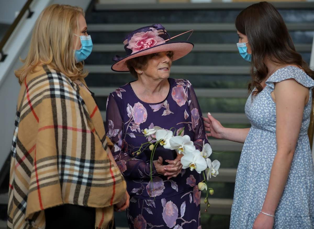Katrina Cameron, primary care paramedic, left and Atlanta Evis, advanced care paramedic, right, celebrate with their former patient Marvel after her wedding in Calgary. Leah Hennel / ALBERTA HEALTH SERVICES