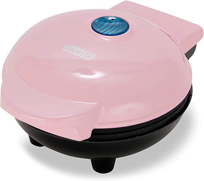 A mini waffle maker in pink.
