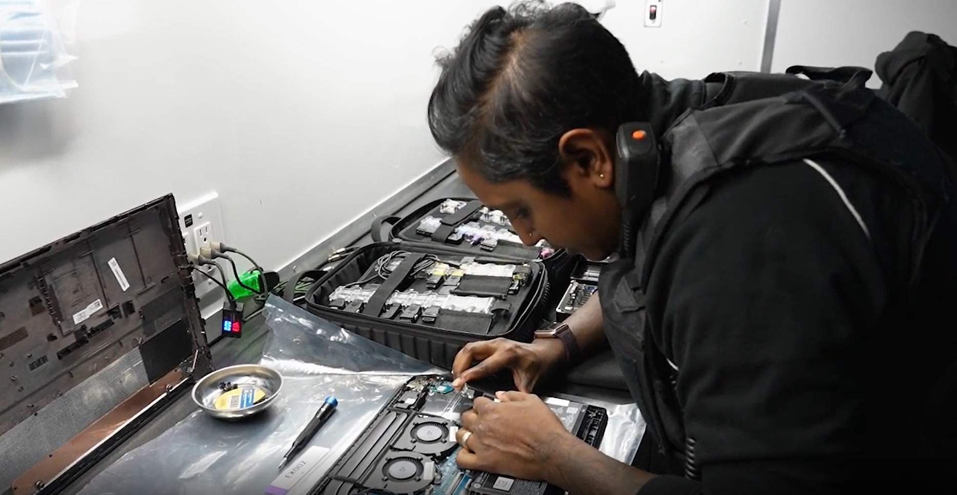 A forensic examiner with the Southern Alberta Child Exploitation unit takes apart a suspect's laptop in MERTL