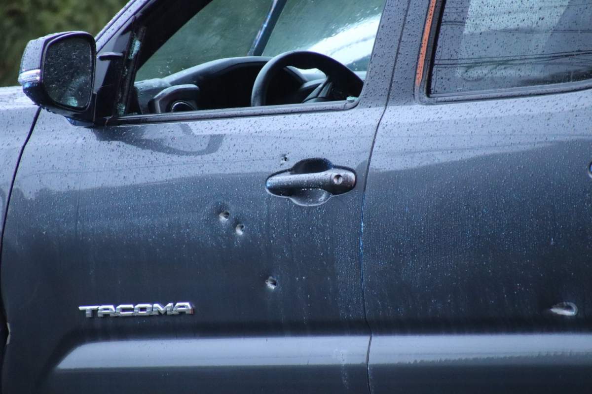 A truck was seen with apparent bullet holes in the driver-side door.