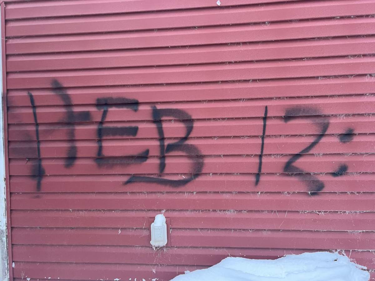 Graffiti of biblical verse on Caitlin Erickson’s home.