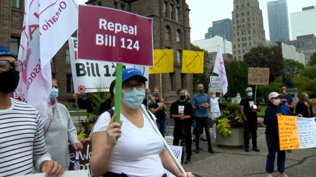 people picketing in front of Queen's Park calling for bill 124 to be repealed.