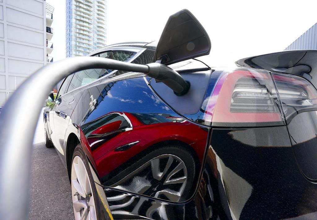 An electric vehicle is charged in Ottawa on Wednesday, July 13, 2022. Parkland Corp. says it is doubling the size of its previously announced electric vehicle charging network in western Canada.