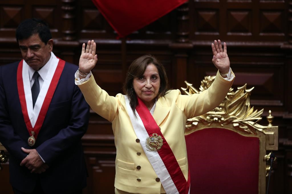 Former Vice President Dina Boluarte acknowledges lawmakers after she was sworn in as president at Congress in Lima, Peru, Wednesday, Dec. 7, 2022. Behind is Congress President Jose Williams. Peru’s Congress voted to remove President Pedro Castillo from office Wednesday and replace him with the vice president, shortly after Castillo tried to dissolve the legislature ahead of a scheduled vote to remove him. (AP Photo/Guadalupe Pardo)