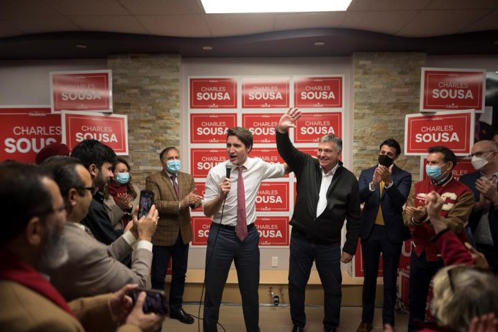 Prime Minster Justin Trudeau delivers remarks next to Charles Sousa at his campaign office, during a byelection campaign stop in Mississauga, Ont., on, Thursday, December 1, 2022. 