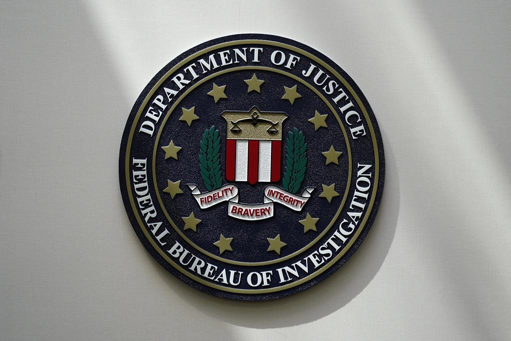 FILE - An FBI seal is seen on a wall on Aug. 10, 2022, in Omaha, Neb. A hacker who reportedly posed as the CEO of a financial institution claims to have obtained access to the more than 80,000-member database of InfraGard, an FBI-run outreach program that shares sensitive information on national security and cybersecurity threats with public officials and private sector individuals who run U.S. critical infrastructure. (AP Photo/Charlie Neibergall, File).