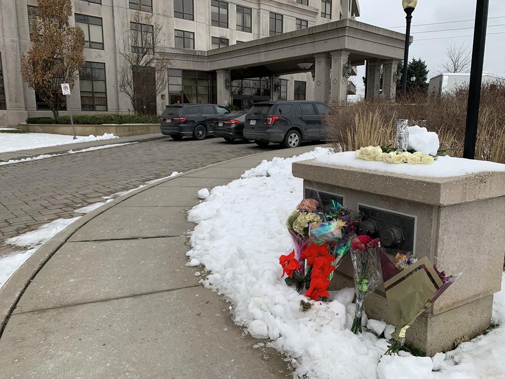 Floral tributes are shown outside a condo building in Vaughan, Ont., Tuesday, Dec. 20, 2022.&nbsp;Heartfelt tributes are pouring in for the five people who were killed over the weekend after a 73-year-old man went door to door gunning down his victims in a Toronto-area condo.&nbsp;THE CANADIAN PRESS/Fakiha Baig.