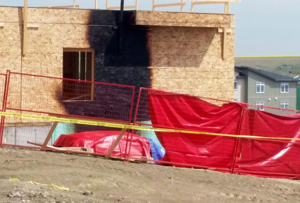 Burn marks from a vehicle fire mar the wall of a house under construction in northwestern Calgary on Monday, July 10, 2017.