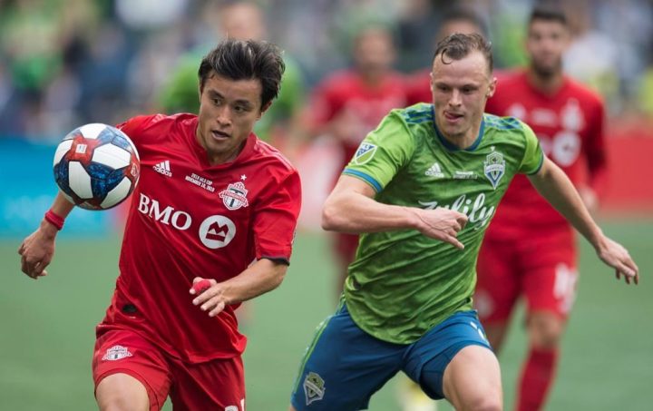 Toronto FC forward Tsubasa Endoh (31) fights for control of the ball with Seattle Sounders defender Brad Smith (11) during the first half of MLS Cup final soccer action in Seattle on Sunday, November, 10, 2019. Endoh is undergoing treatment in his native Japan for acute leukemia. 