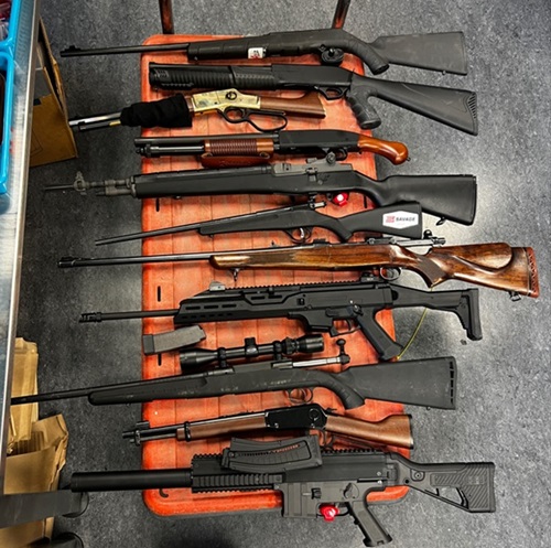 Police found 11 firearms, including a loaded lever action rifle and a loaded 12-gauge shotgun.