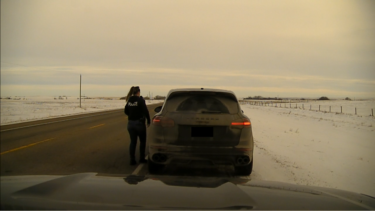 A Strathmore RCMP officer approaches a vehicle during a traffic stop on Dec. 8, 2022, after that vehicle was observed going nearly 150 km/h.