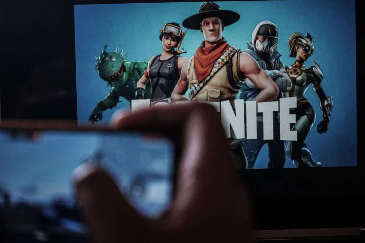 Fortnite characters in the background. An iPhone is in the foreground.