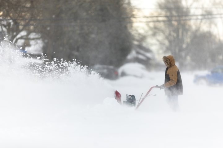 A man uses a snowblower in Fort Erie, Ont., on Saturday, Nov. 19, 2022. 