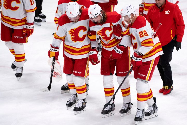 Calgary Flames defenceman Chris Tanev leaves game after taking shot to head