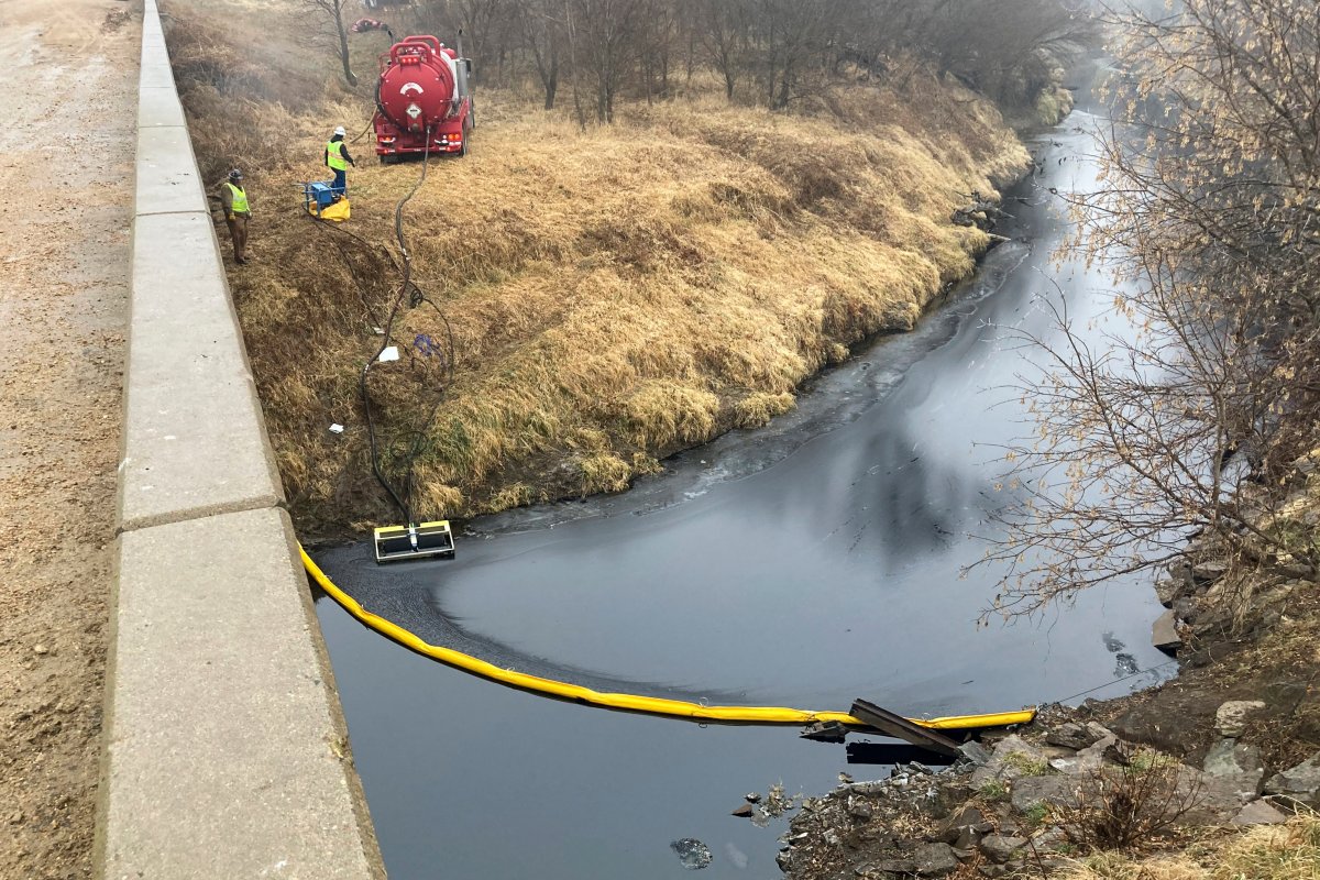 A remediation company deploys a boom on the surface of an oil spill after a Keystone pipeline ruptured at Mill Creek in Washington County, Kansas, on Thursday, Dec. 8, 2022.