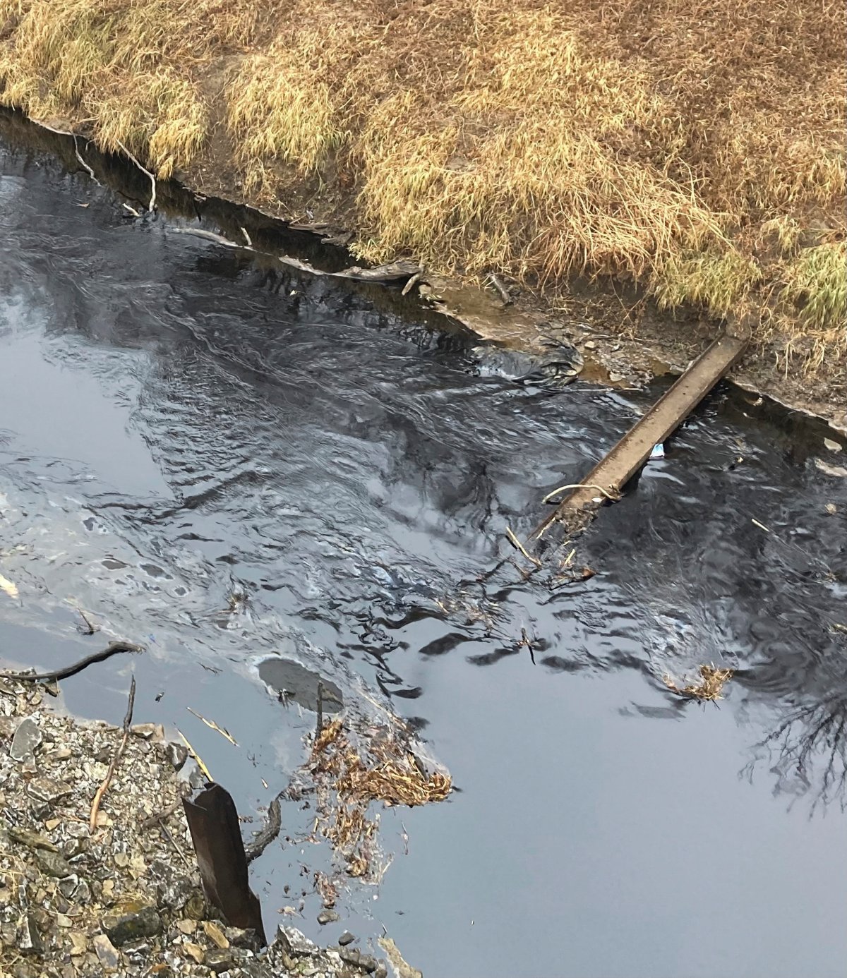 Oil from a Keystone pipeline rupture flows into Mill Creek in Washington County, Kansas, on Thursday, Dec 8, 2022.