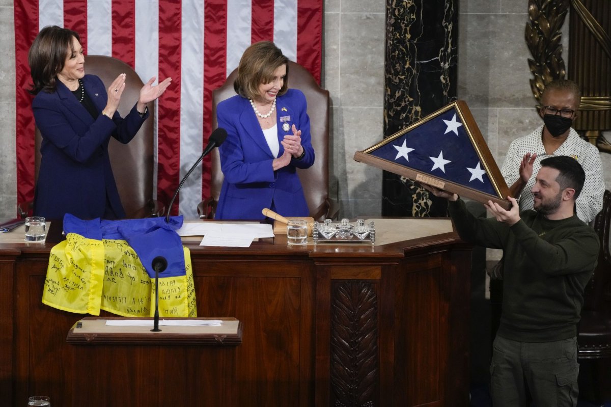 Ukrainian President Volodymyr Zelenskyy, right, holds up an American flag that was gifted to him by House Speaker Nancy Pelosi of Calif., and Vice President Kamala Harris, after he addressed a joint meeting of Congress on Capitol Hill in Washington, Wednesday, Dec. 21, 2022. (AP Photo/Jacquelyn Martin)