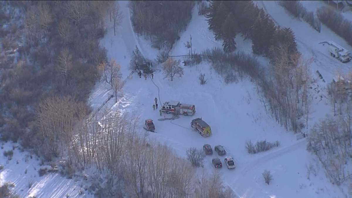 Emergency responders attend a burning SUV in Foothills County on Dec. 15, 2022.