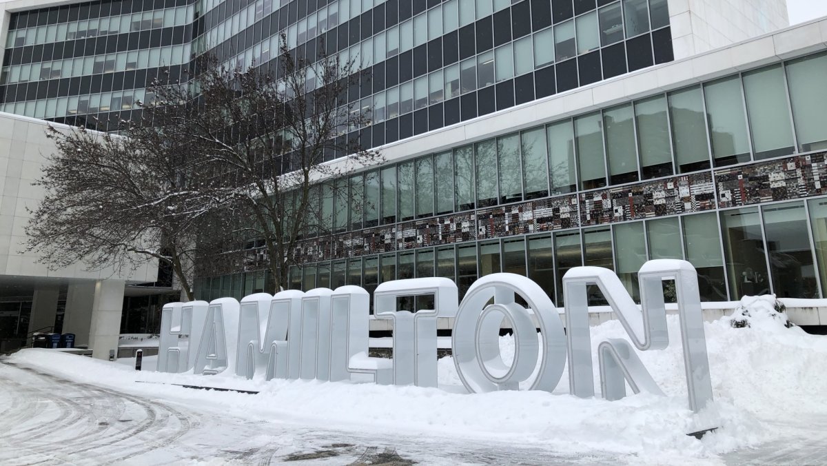 The Hamilton sign in front of city hall is blanketed in snow after a snowstorm in early 2022.