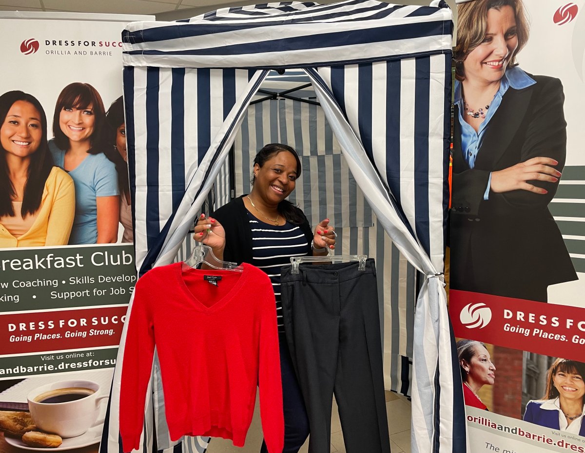 Dress for Success Orillia and Barrie boutique co-ordinator Rosie Williams is pictured with the charity's changeroom tent that it uses for pop-up workwear events all over Simcoe County.