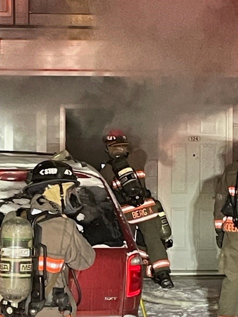 Saskatoon firefighters force open a door to a motel suite that caught fire due to improper disposal of smoking materials.