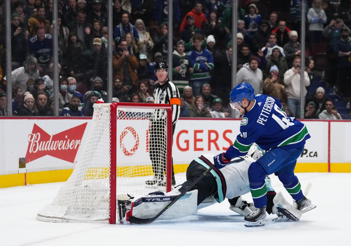Elias Pettersson of the Vancouver Canucks scores the game-winning goal during NHL action against the Seattle Kraken in Vancouver on Thursday night. The game went to a shootout after Vancouver rallied from a 5-3 deficit to tie the game in the third period.