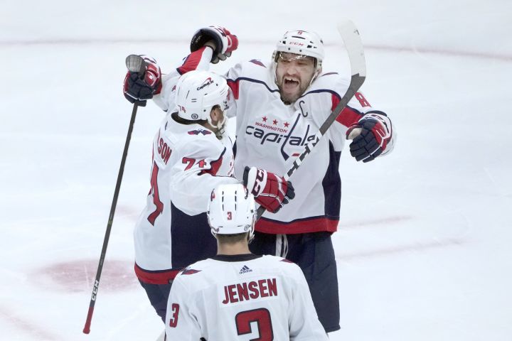 Washington Capitals’ Alex Ovechkin, right, celebrates his 800th career goal, on a hat trick against the Chicago Blackhawks with John Carlson and Nick Jensen during the third period of an NHL hockey game Tuesday, Dec. 13, 2022, in Chicago.