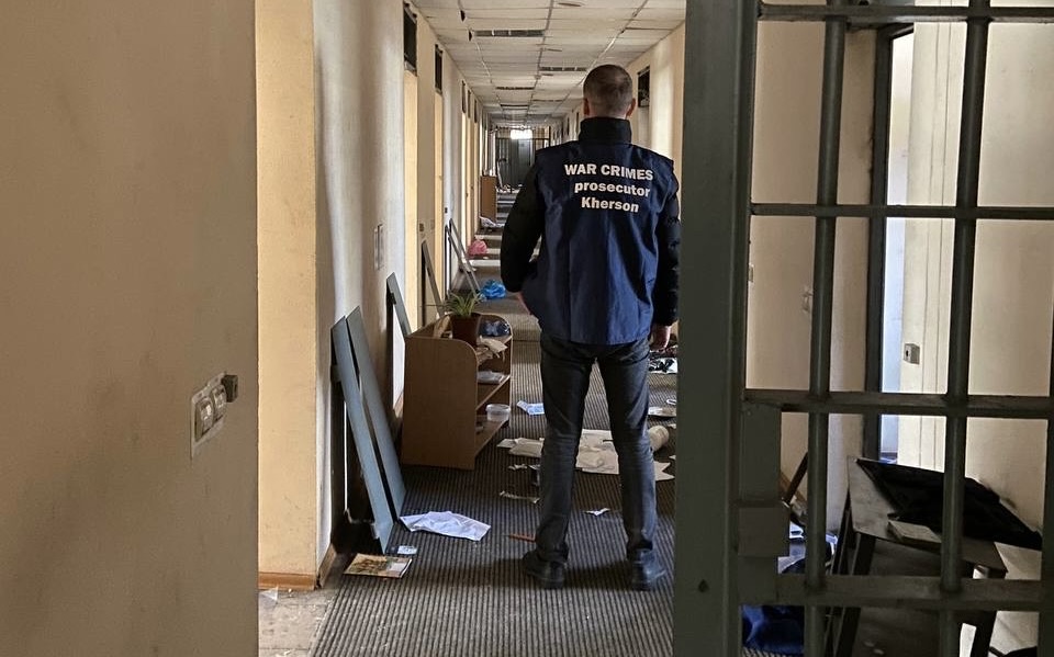 Ukrainian war crimes investigator at building in Kherson used by Russian forces as a torture centre.
